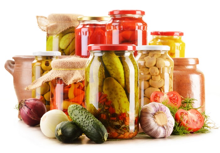 Jars of Pickled Vegetables and Mushrooms with Fresh Produce