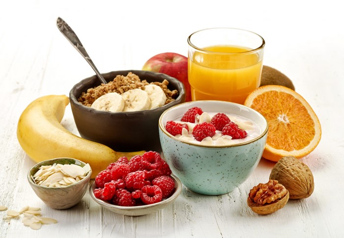 Healthy Breakfast with Muesli, Fruits, Juice, and Nuts