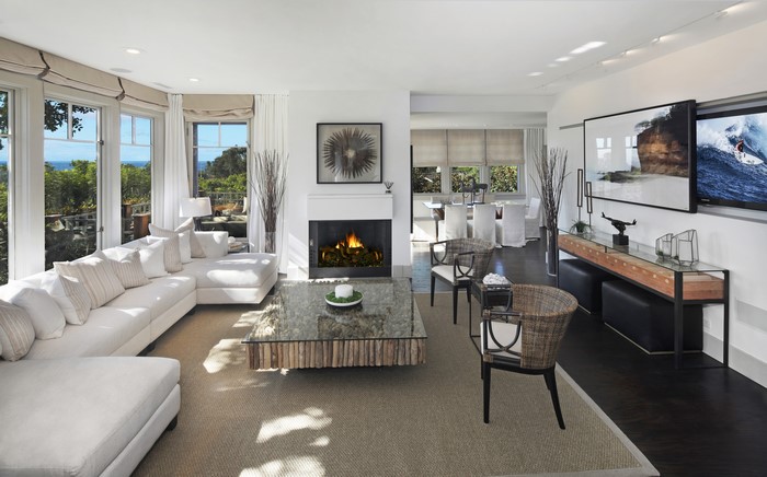 Living room with sofa, fireplace, and dining area
