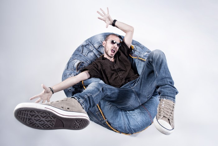 Man in Jeans Sitting on a Denim Armchair