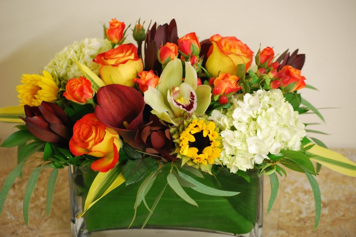 Floral arrangement with roses, orchids, hydrangeas, and callas