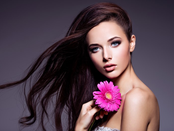 Beautiful Brown-Haired Woman with Pink Gerbera
