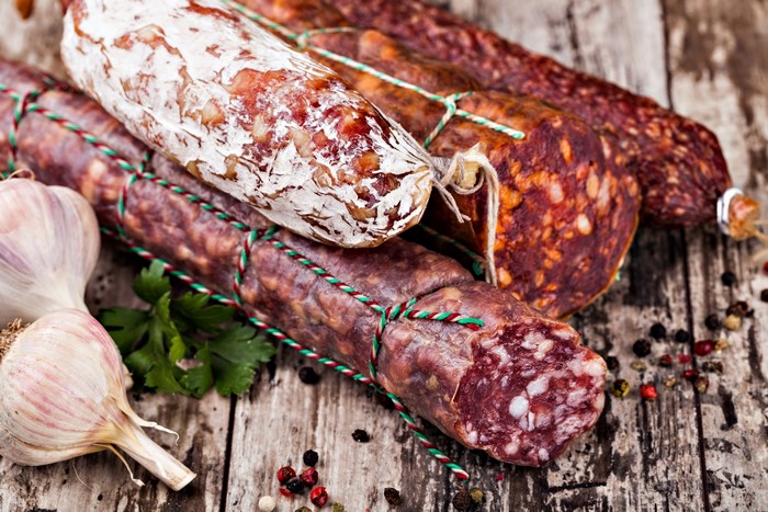 Sausages and Garlic on Wood Planks