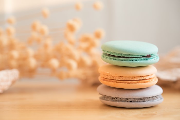 Stack of colorful macarons on a wooden table
