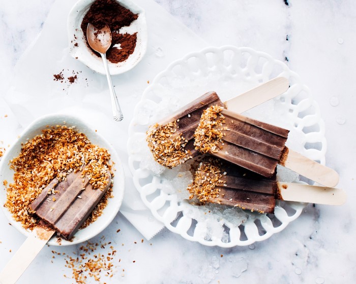 Chocolate popsicles with toasted coconut and cocoa powder