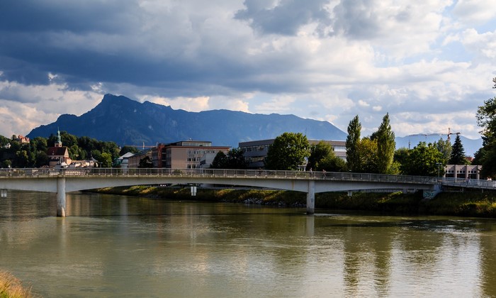 Bridge over a river in Salzburg, Austria with mountains