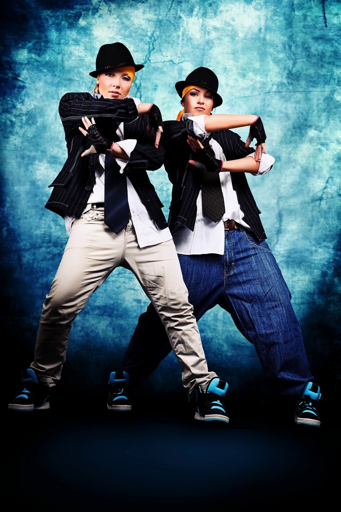 Two dancers in hats and suits posing