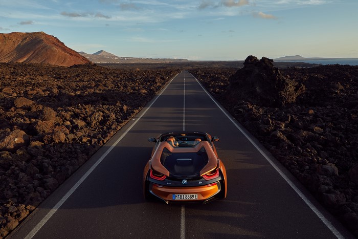 4K Orange BMW i8 Roadster on a Road