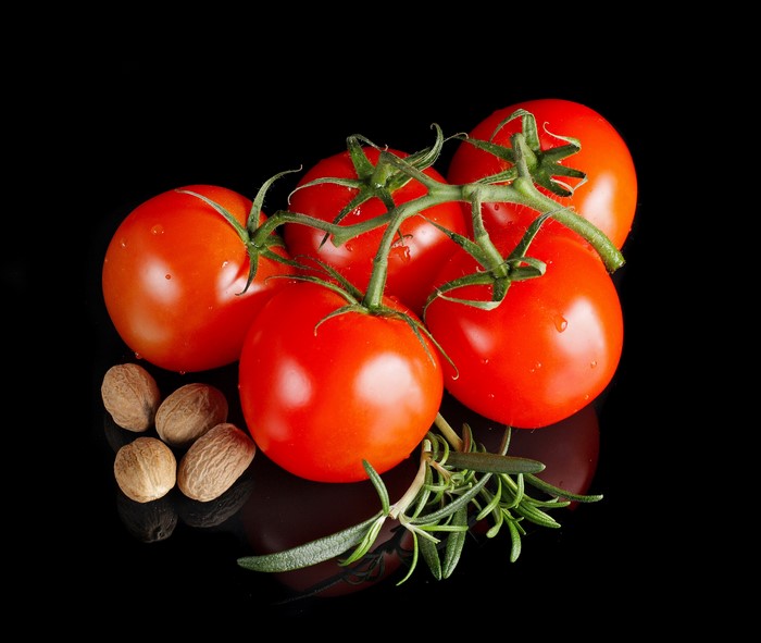 Tomatoes with Nutmeg and Rosemary on Black Background