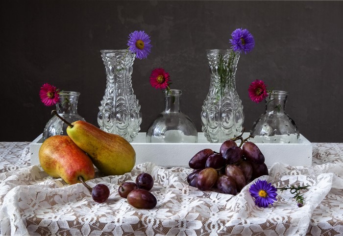 Still-life with pears, grapes, flowers, and vases