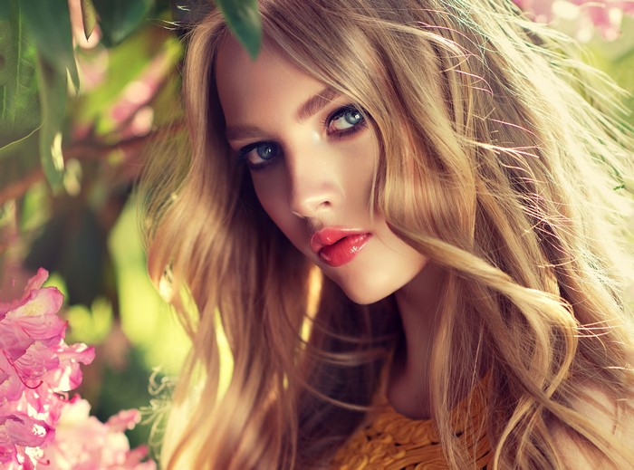 Blonde girl with blue eyes and pink flowers