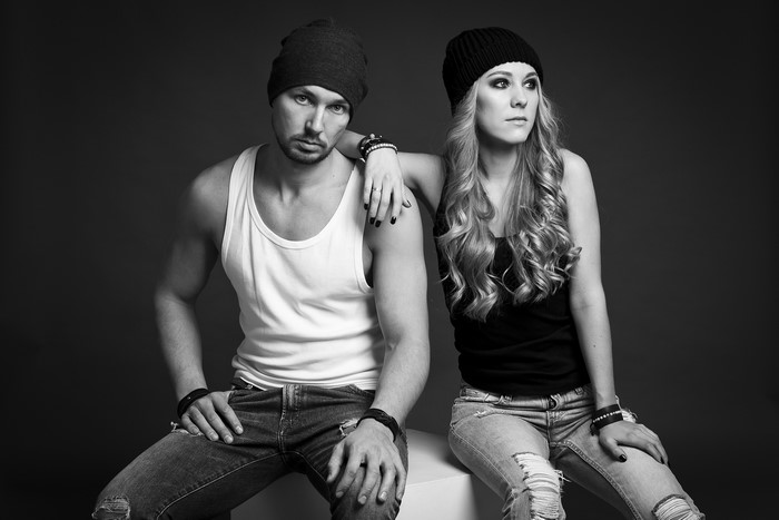 Man and woman wearing winter hats and ripped jeans
