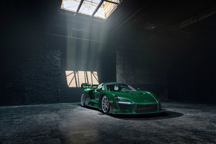 Green McLaren Senna in a dark garage