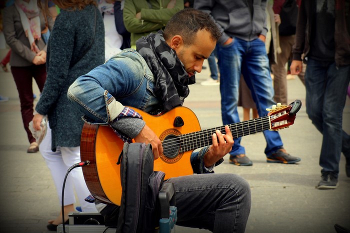 Man playing guitar on street
