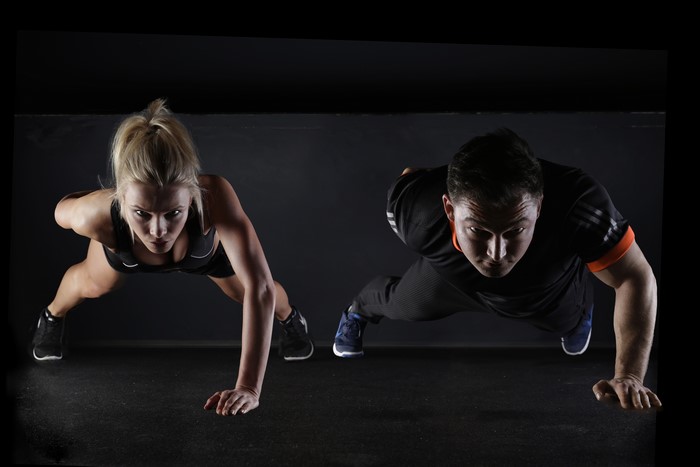 Man and woman doing push-ups