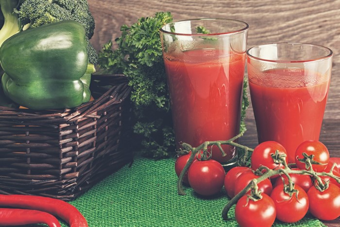 Two glasses of tomato juice with tomatoes and vegetables
