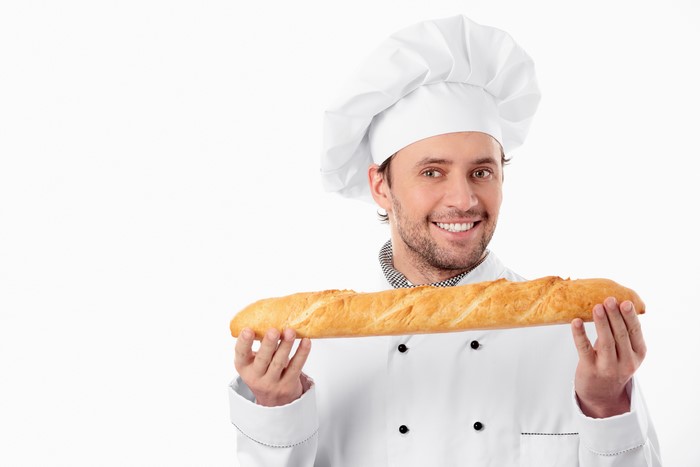 Baker holding a baguette