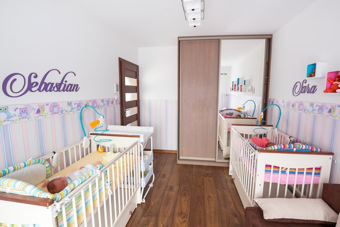 Children's room with two cribs and name decorations