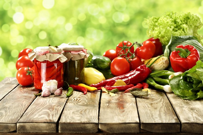 4K Vegetables and Jars on Wood Planks