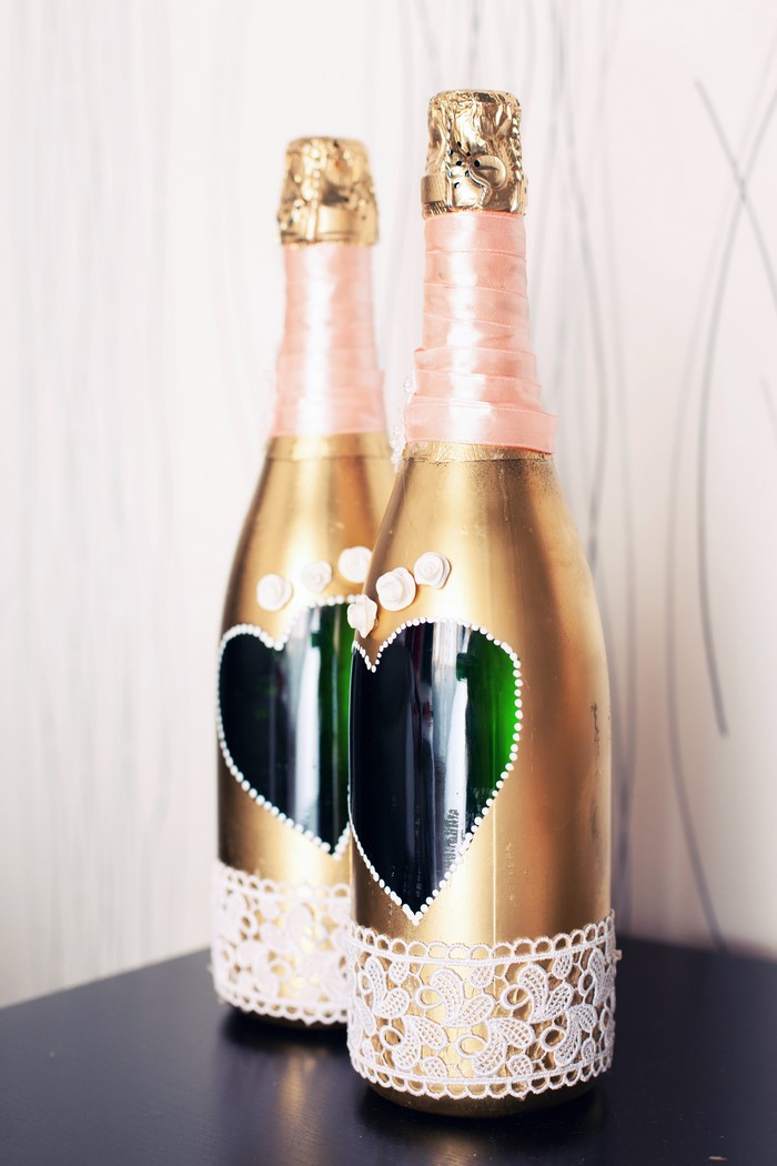 Two decorated champagne bottles for a wedding