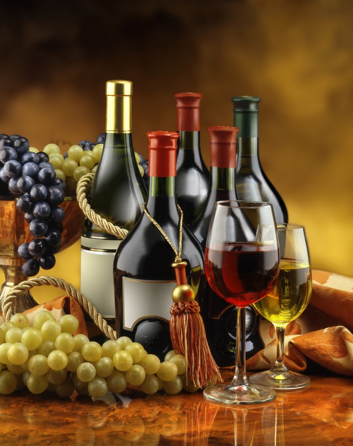 Wine bottles and grapes with stemware