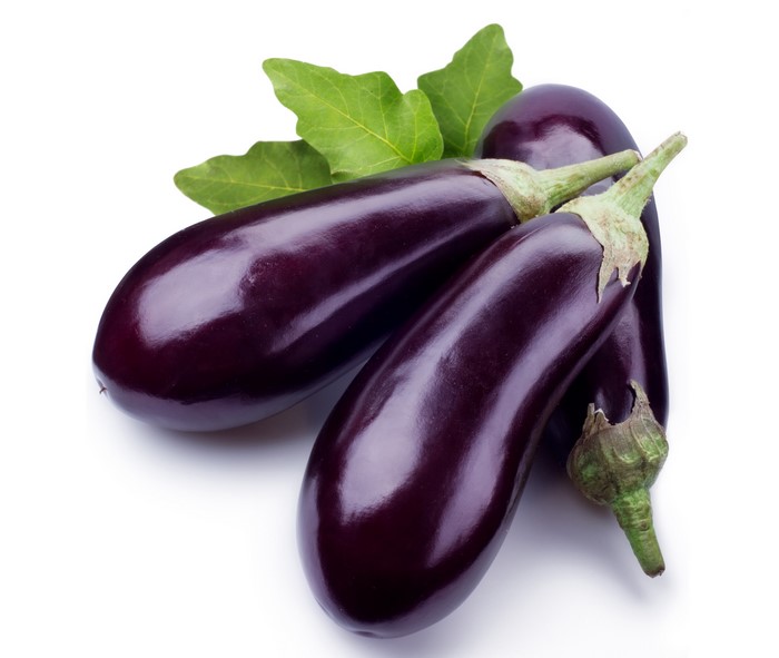 Three eggplants with green leaves on white background