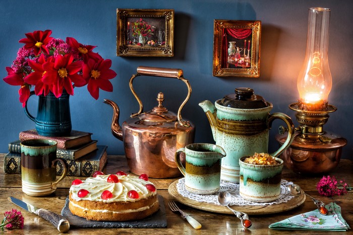 Still-life with cake, tea set, and lamp
