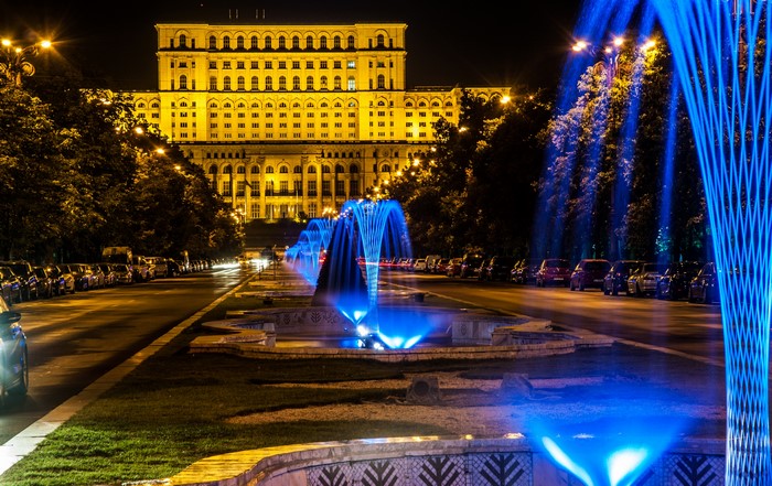 Palace of the Parliament and illuminated fountains in Bucharest, Romania at night