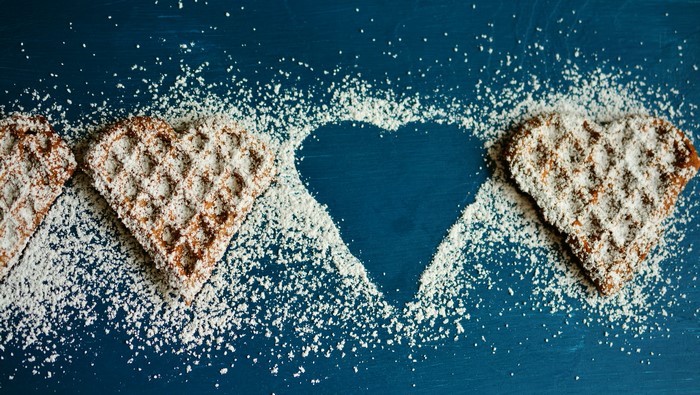 Heart-shaped waffles with powdered sugar