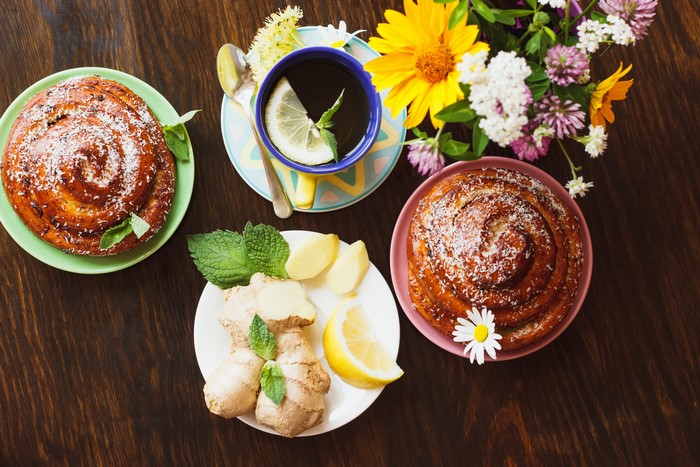Tea with pastries, lemons, and flowers