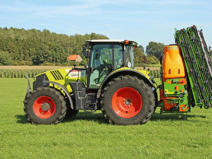 Claas Arion 650 tractor with sprayer attachment