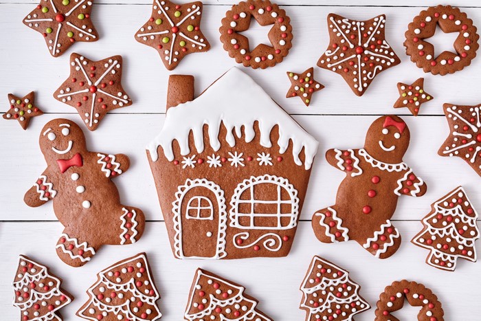 Christmas gingerbread cookies on white wooden background