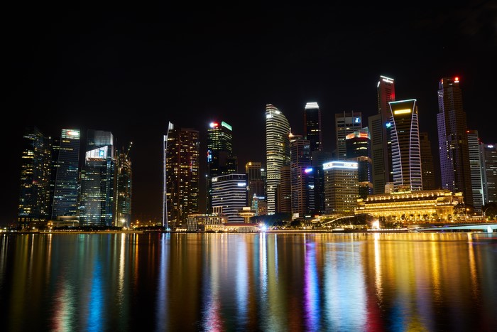 Singapore skyscrapers at night with reflections