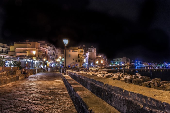 Night view of Ischia Ponte, Italy with illuminated buildings and street lights