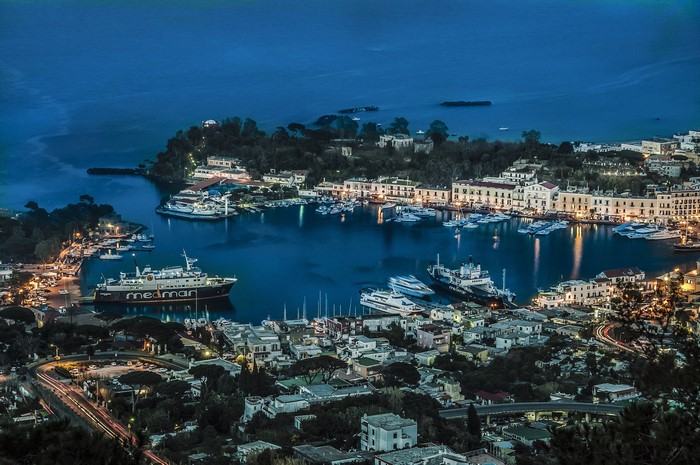 Ischia, Italy harbor at dusk with boats and buildings