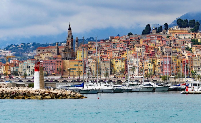 Menton, France harbor with lighthouse and sailboats