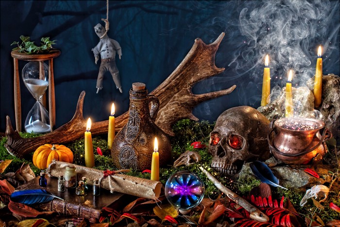 Still-life with Halloween objects, candles, and skull