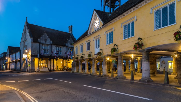 Tetbury, England street at dusk with buildings and streetlights
