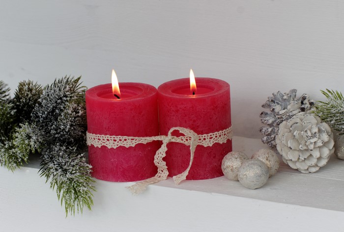 Christmas candles with pine cones and fir branches