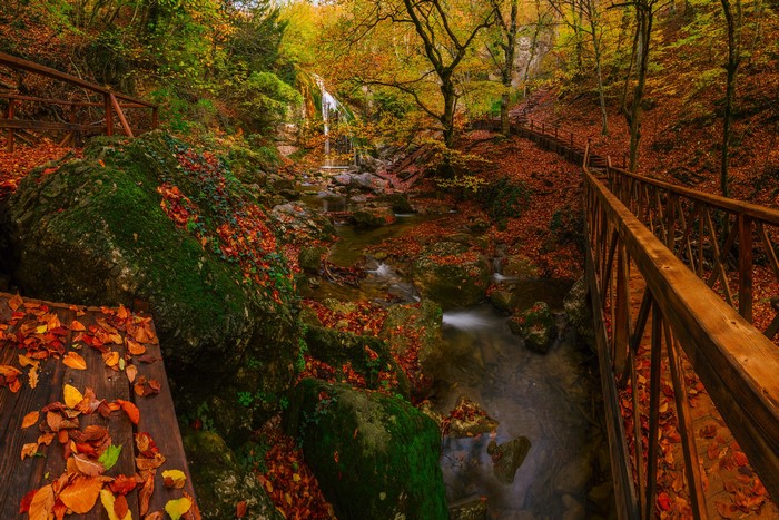 Autumn waterfall with wooden bridge in Crimea, Russia
