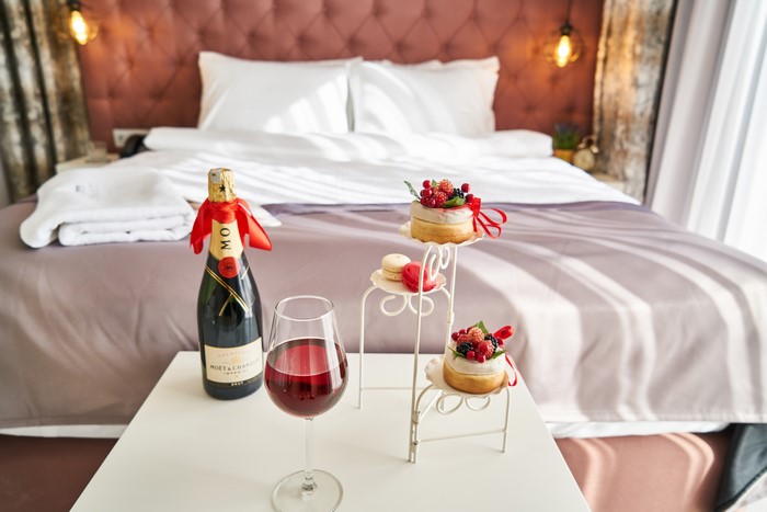 Champagne bottle and wine glass on a table in a hotel room