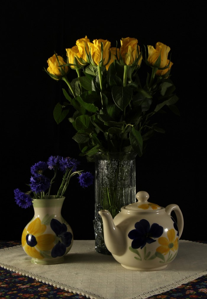 Still-life with yellow roses, cornflowers, and a teapot