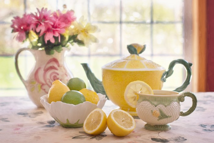 Tea set with lemons and flowers