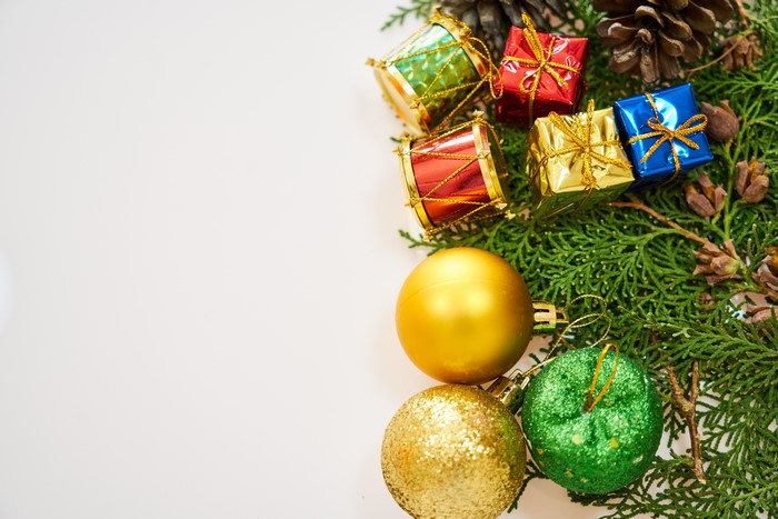 Christmas ornaments and pine cones on a white background