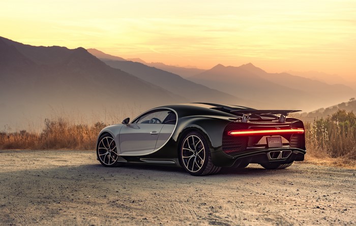 Bugatti Chiron rear view on a mountain road at sunset