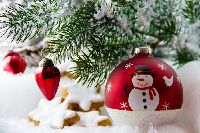 Christmas ornaments and cookies on a spruce branch