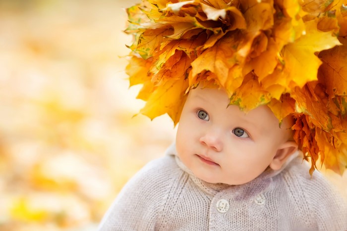 Baby wearing a crown of autumn leaves