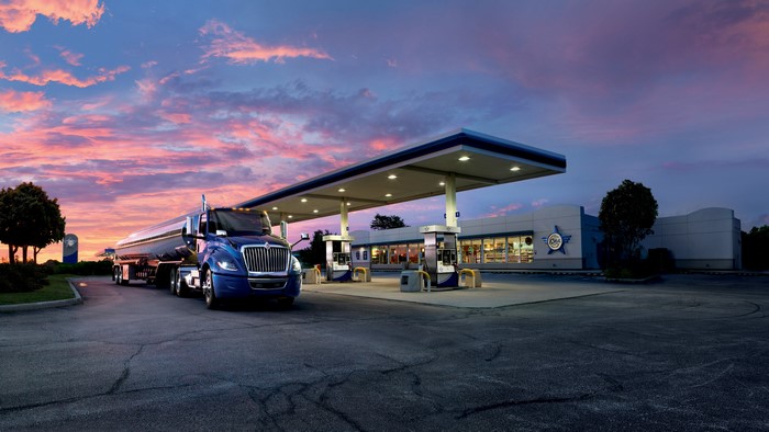 Blue International truck at a gas station