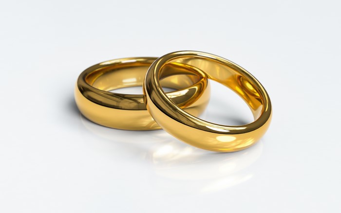 Two Gold Rings on White Background