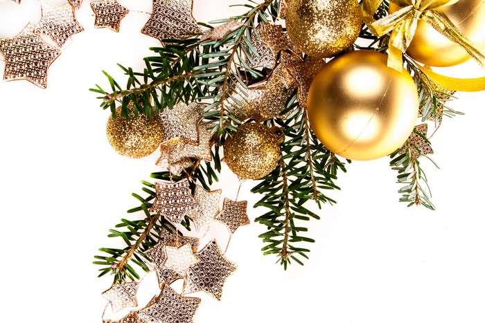 Christmas tree branches with gold ornaments and stars
